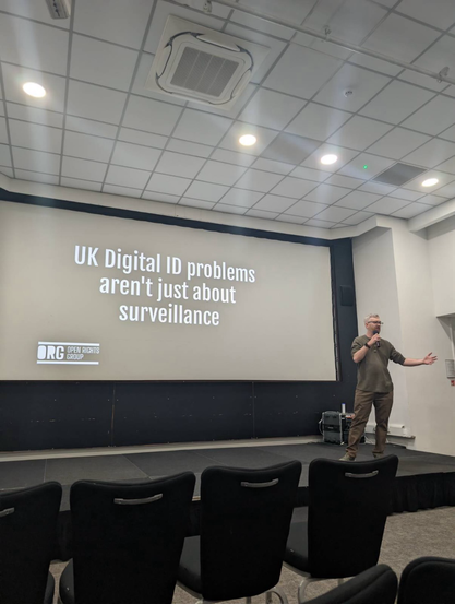 Picture of presenting a talk on digital ID on stage 